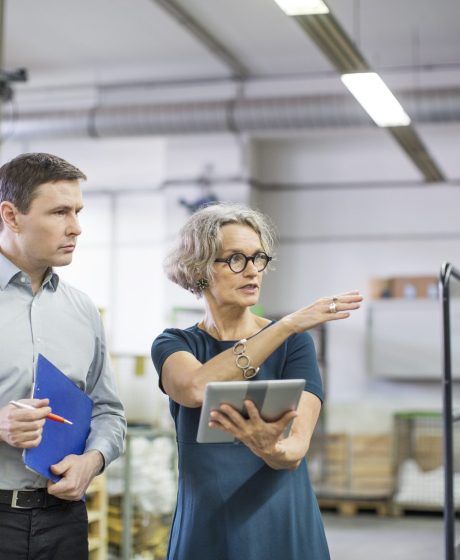 Manager discussing with male worker at printing plant